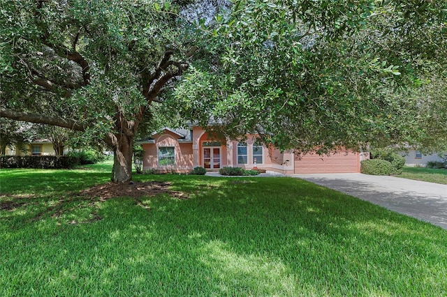 view of property hidden behind natural elements featuring a front lawn