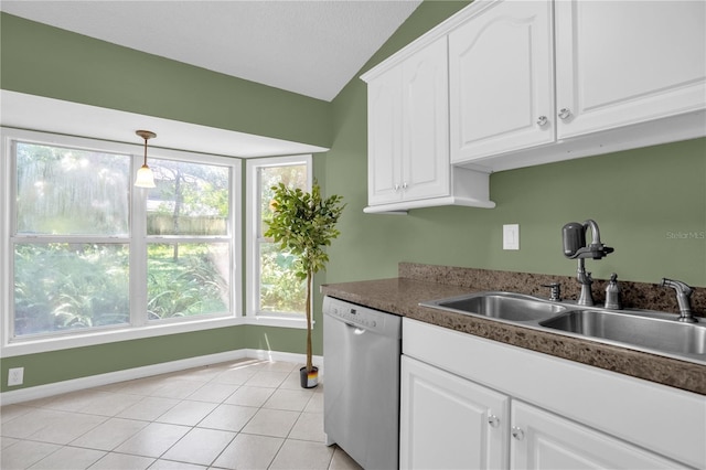 kitchen featuring dishwasher, white cabinets, light tile patterned floors, and a healthy amount of sunlight