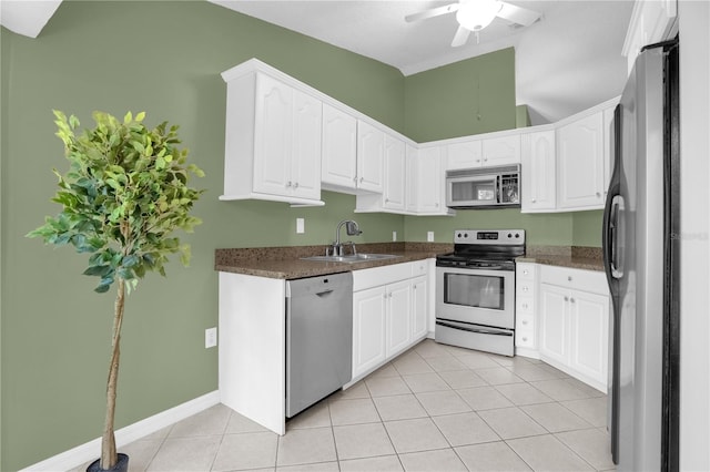 kitchen featuring ceiling fan, white cabinets, appliances with stainless steel finishes, sink, and light tile patterned flooring