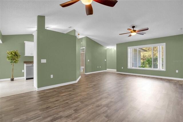 spare room with ceiling fan, light wood-type flooring, and lofted ceiling