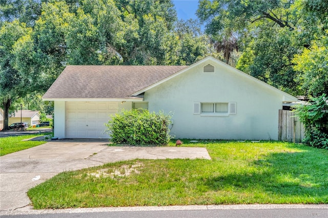 single story home featuring a garage and a front lawn