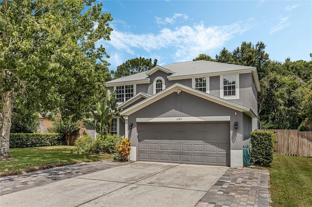 front facade with a garage and a front yard