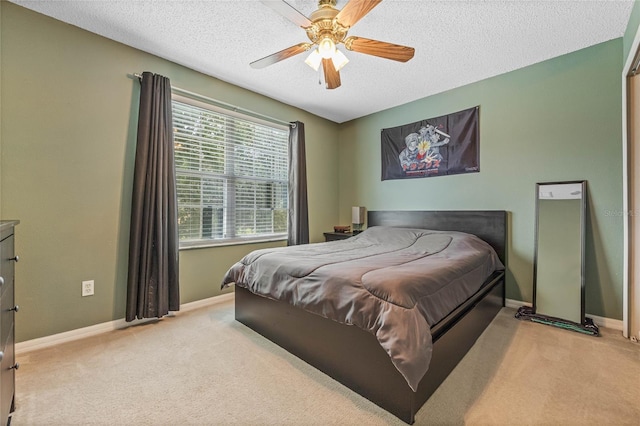 carpeted bedroom featuring a textured ceiling and ceiling fan