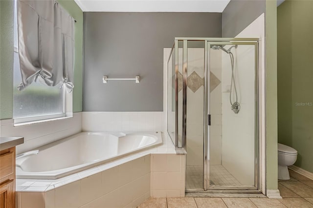 full bathroom featuring tile patterned floors, independent shower and bath, and toilet