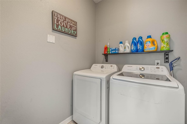 clothes washing area with washer and clothes dryer