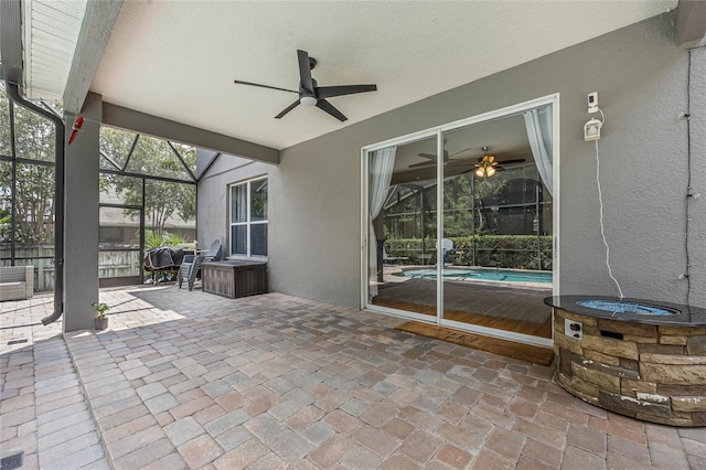 view of patio / terrace featuring glass enclosure and ceiling fan