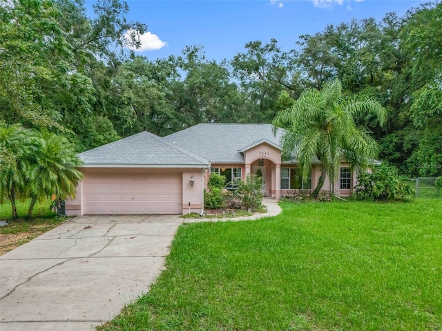 view of front of house with a garage and a front yard