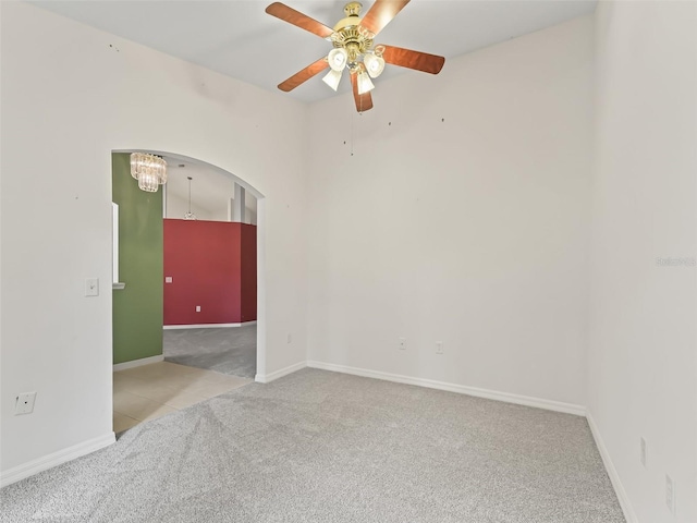 empty room with ceiling fan and light colored carpet