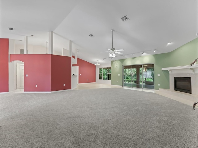 unfurnished living room featuring ceiling fan, light carpet, high vaulted ceiling, and rail lighting