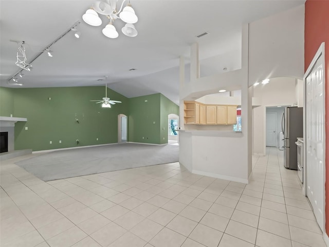 kitchen with light brown cabinets, light colored carpet, ceiling fan with notable chandelier, stainless steel refrigerator, and track lighting