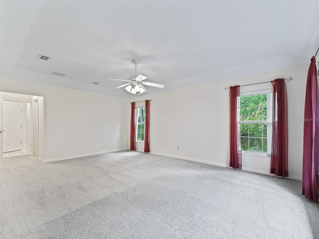 carpeted spare room featuring ceiling fan