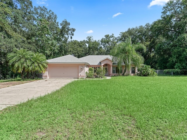 single story home featuring a garage and a front yard