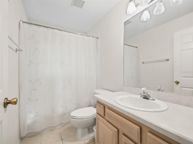 bathroom with tile patterned flooring, vanity, and toilet