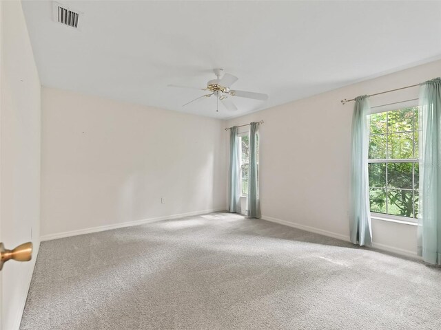 empty room with ceiling fan and carpet