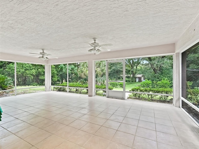 unfurnished sunroom with plenty of natural light and ceiling fan