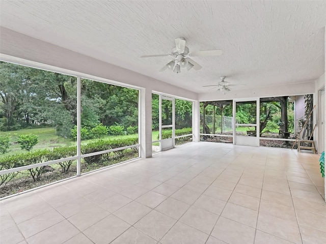 unfurnished sunroom with ceiling fan