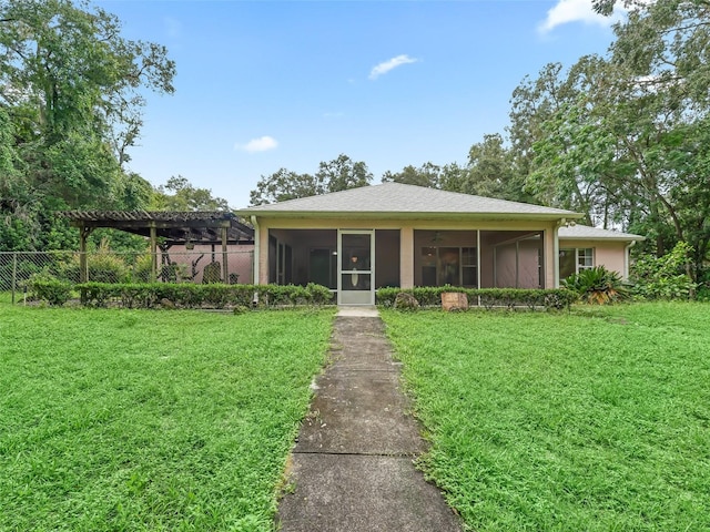 view of front of property featuring a sunroom and a front yard