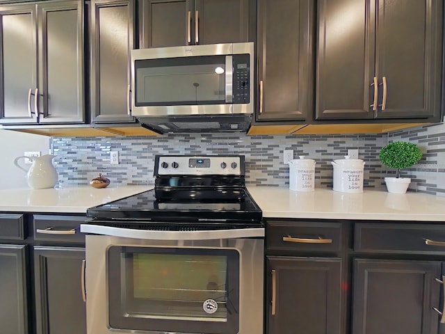 kitchen with stainless steel appliances, backsplash, and light countertops