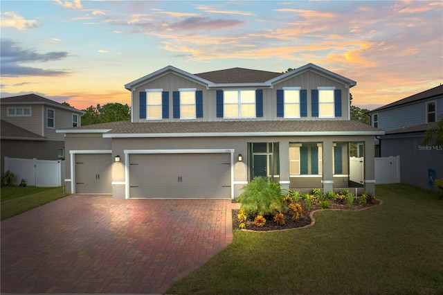 view of front facade with a garage and a lawn