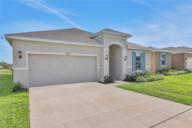 view of front of property with a front lawn and a garage