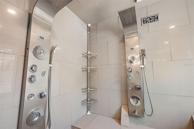 bathroom with tiled shower