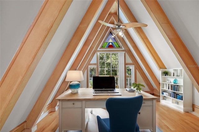 office featuring ceiling fan, light wood-type flooring, vaulted ceiling, and built in shelves