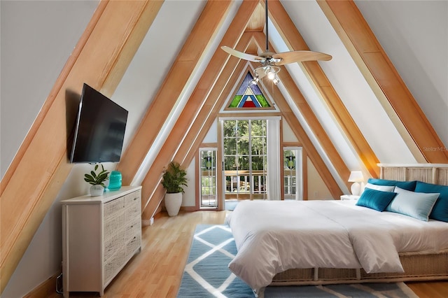 bedroom featuring light hardwood / wood-style floors, access to exterior, ceiling fan, and lofted ceiling