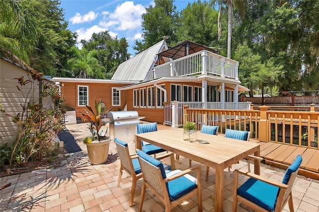 back of house featuring a wooden deck and a patio