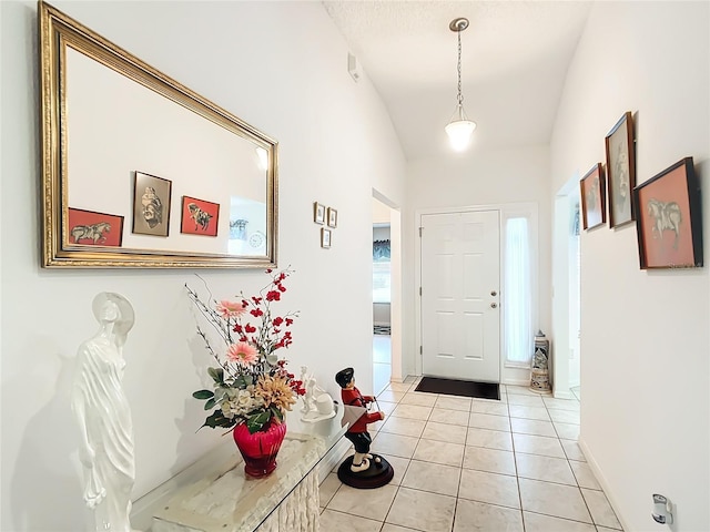 entrance foyer featuring lofted ceiling and light tile patterned floors