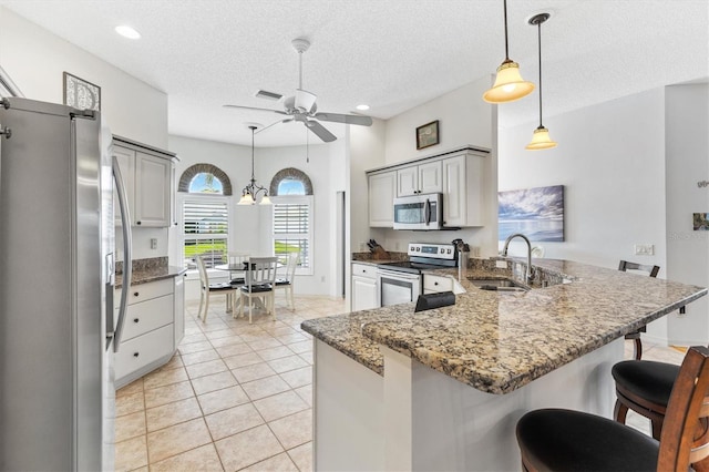 kitchen featuring sink, gray cabinetry, light tile patterned flooring, and stainless steel appliances