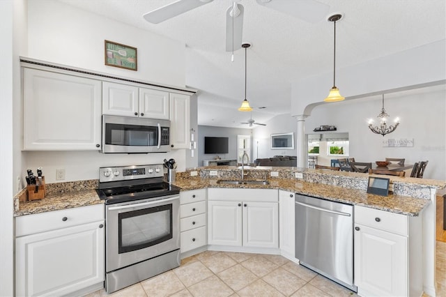 kitchen featuring sink, white cabinetry, ceiling fan with notable chandelier, and stainless steel appliances