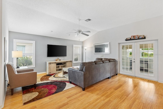 living room featuring light hardwood / wood-style flooring, ceiling fan, french doors, and plenty of natural light