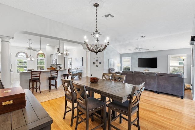 dining space featuring ceiling fan with notable chandelier, light hardwood / wood-style flooring, and plenty of natural light