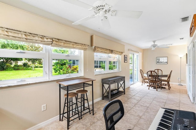 tiled dining room featuring ceiling fan