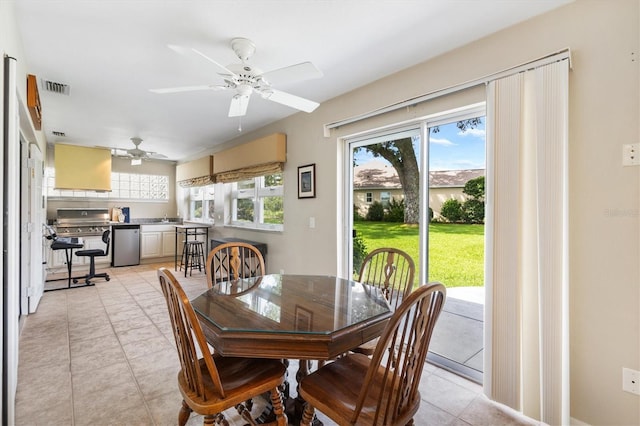 dining area featuring ceiling fan, plenty of natural light, and light tile patterned floors