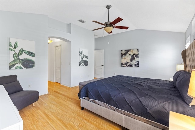 bedroom featuring ceiling fan, light wood-type flooring, and lofted ceiling