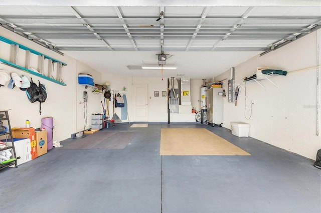 garage featuring a garage door opener and water heater