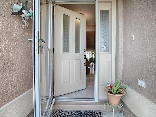 doorway to property with stucco siding