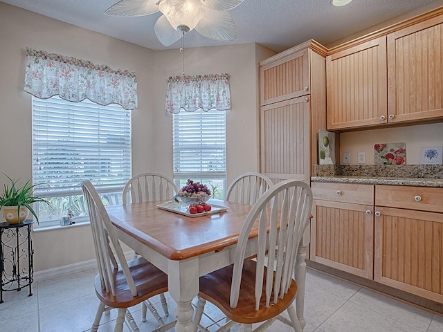 tiled dining space with ceiling fan