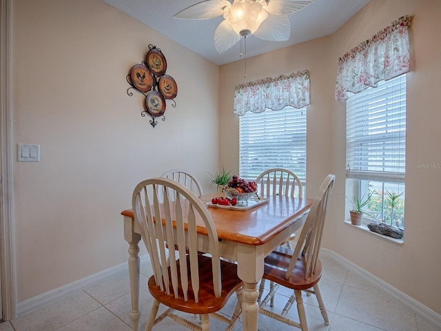 tiled dining space featuring ceiling fan