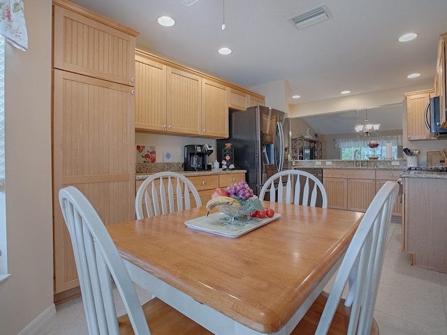 dining area featuring light tile patterned flooring and sink