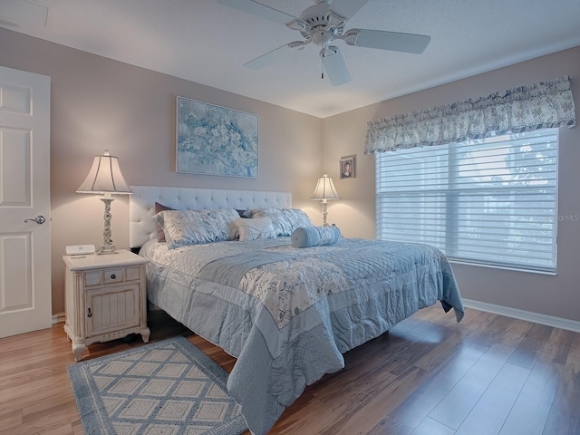 bedroom with ceiling fan and light hardwood / wood-style floors