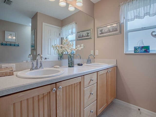 bathroom featuring tile patterned flooring and vanity