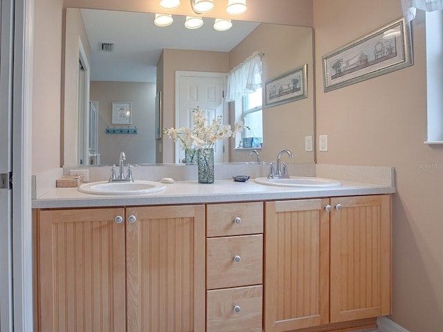 full bathroom with double vanity, a sink, and visible vents