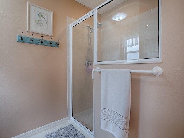 bathroom with tile patterned floors and an enclosed shower