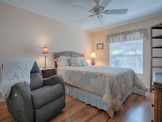 bedroom featuring ceiling fan and hardwood / wood-style flooring