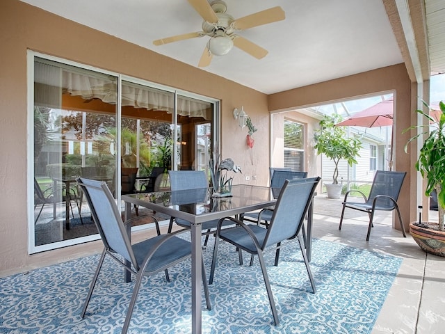 sunroom featuring a ceiling fan