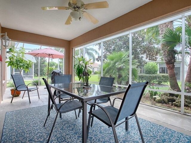 sunroom featuring ceiling fan