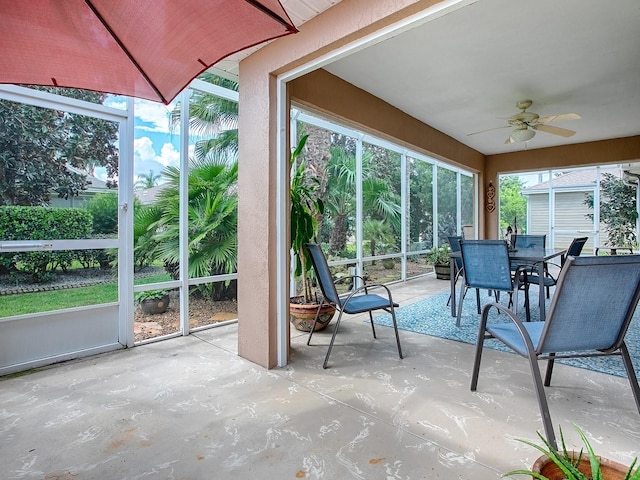 unfurnished sunroom featuring ceiling fan