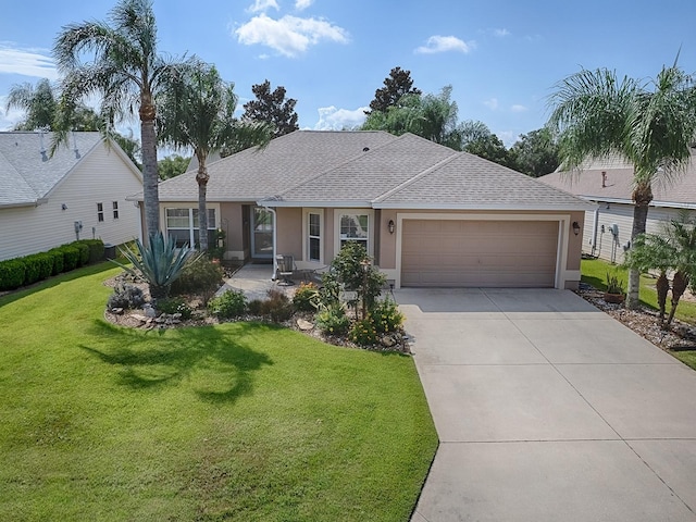 ranch-style house featuring a front yard, concrete driveway, an attached garage, and stucco siding